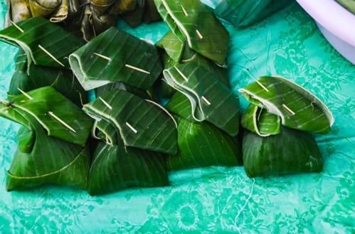 Laotian steamed fish is wrapped in banana leaf.