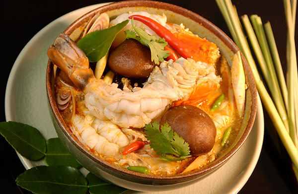 Tom yam is characterised by its distinct hot and sour flavours provided by a broth of stock, lemongrass, kaffir lime leaves, galangal, lime juice, fish sauce, and crushed chilli.