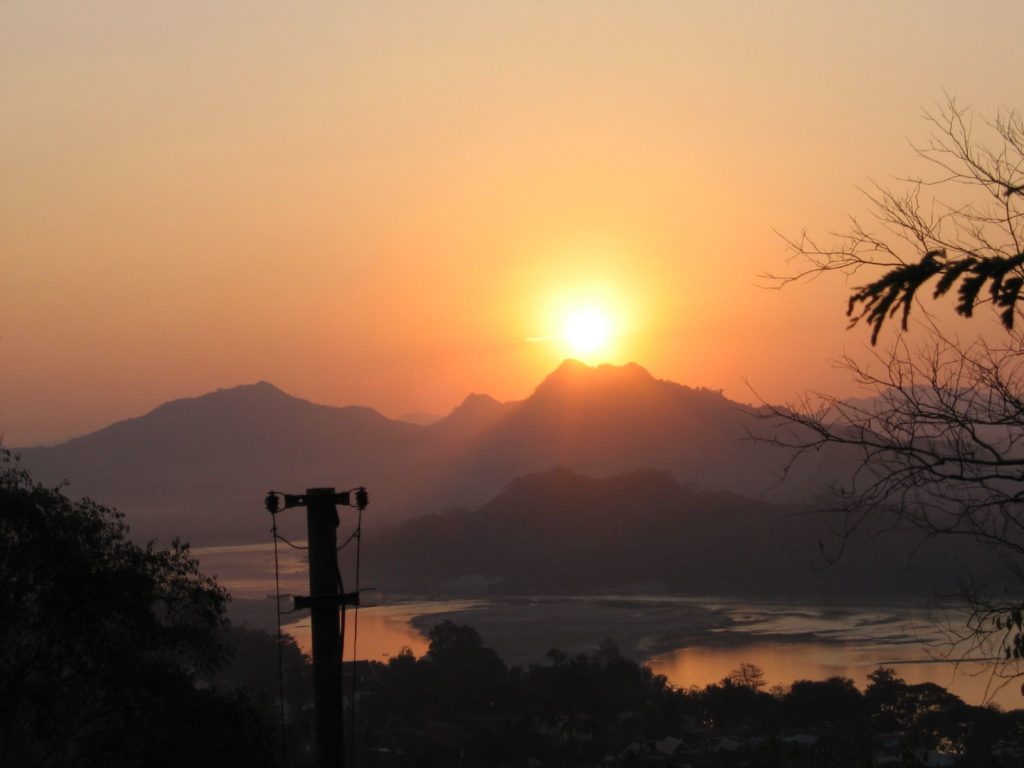 Sun setting over LuangPrabang, as seen from Phu Si Hill. Image courtesy of Shannon Shue/Creative Commons