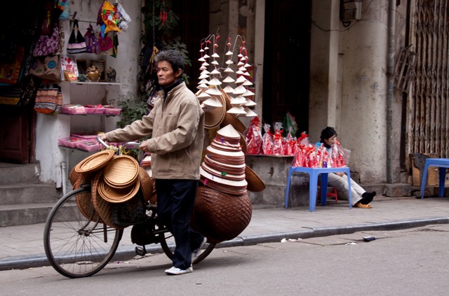Conical hat & basket vendor in the Old Quarter, Hanoi, Vietnam